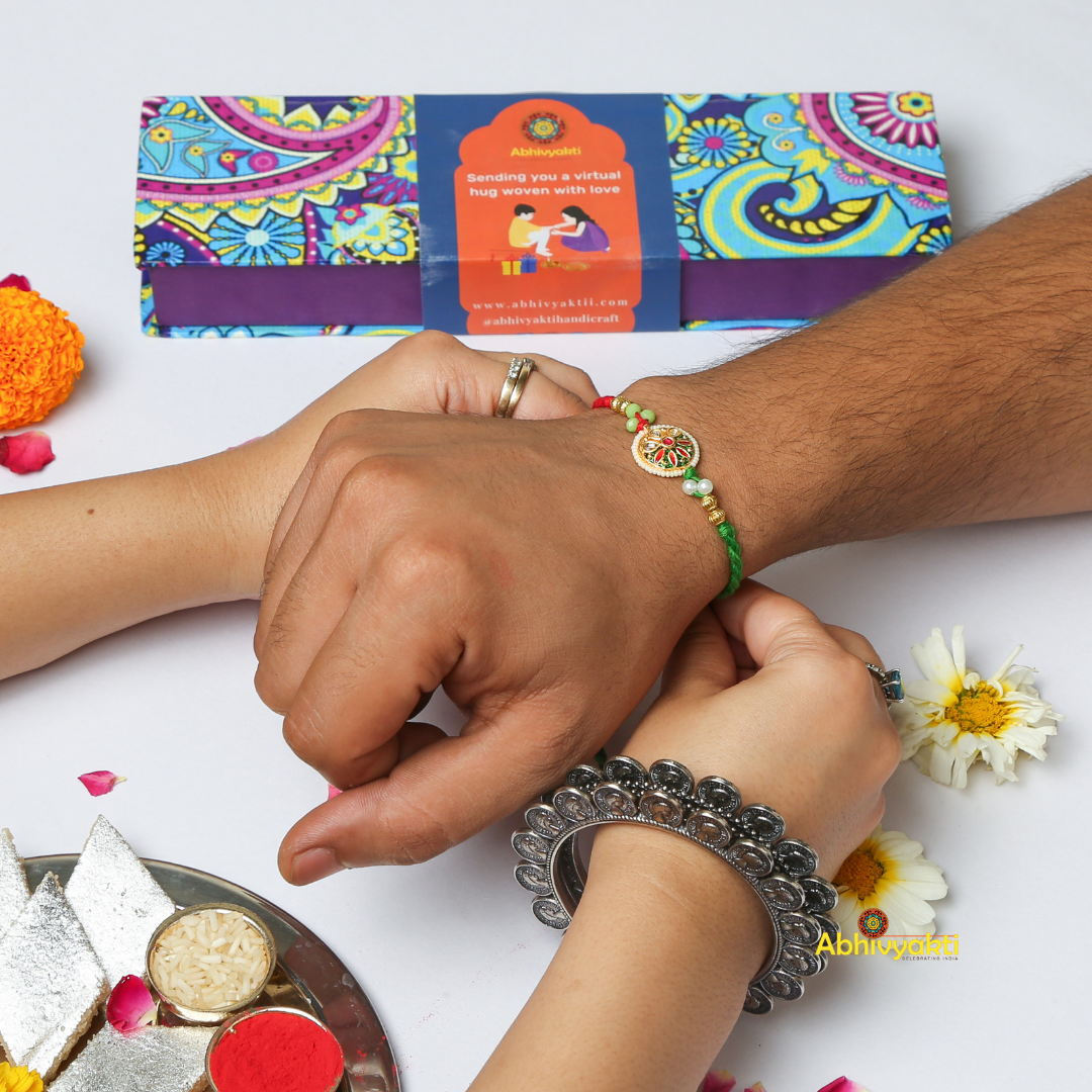 Sister tying a beautiful ornate rakhi to her brother and celebrating rakshabandhan in traditional Indian way