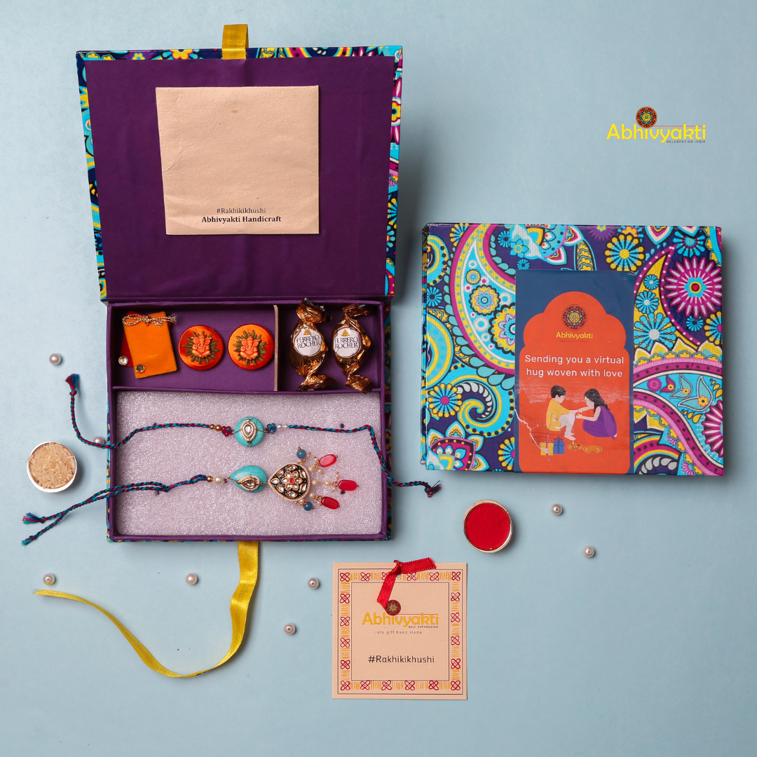 Elegant designer rakhi featuring turquoise blue stones, kundan embellishments, red crystal beads, and pearl hangings on a braided multicolor thread – perfect for a festive Raksha Bandhan celebration