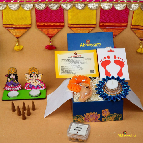 A festive Diwali hamper filled with an assortment of decorative items and treats. The hamper includes colorful floating diya, a box of mithai sweet candle, fragrant incense sticks, a small decorative toran, and festive Ganesh Lakshmi tealight alongwith tangy juicy mango roll up . The items are beautifully arranged in a festive box with vibrant, rich colors and intricate detailing, evoking the spirit of Diwali celebrations. The hamper is a perfect gift for the festive vibe