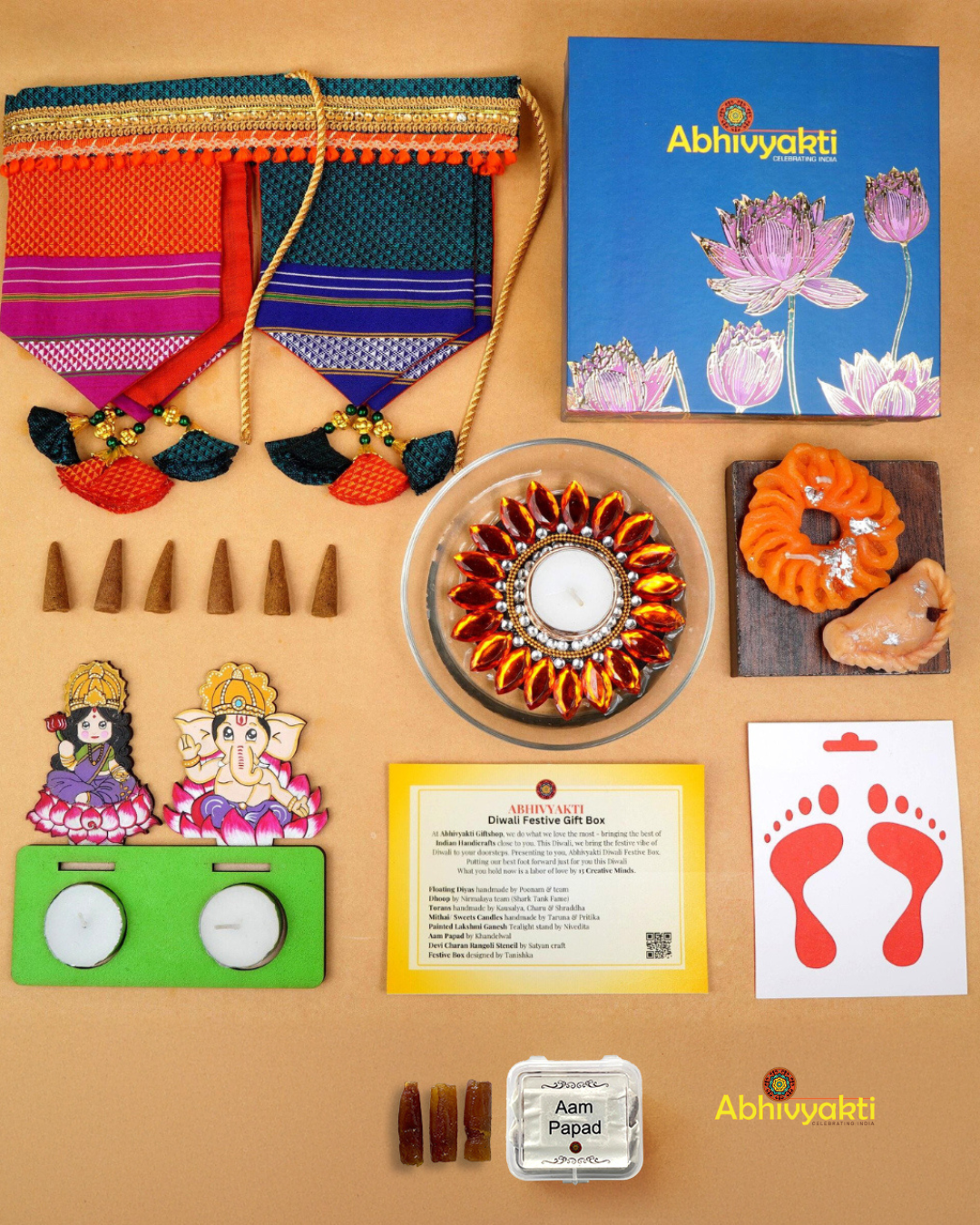 A festive Diwali hamper filled with an assortment of decorative items and treats. The hamper includes colorful floating diya, a box of mithai sweet candle, fragrant incense sticks, a small decorative toran, and festive Ganesh Lakshmi tealight alongwith tangy juicy mango roll up . The items are beautifully arranged in a festive box with vibrant, rich colors and intricate detailing, evoking the spirit of Diwali celebrations. The hamper is a perfect gift for the festive vibe