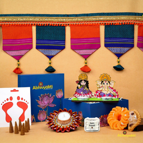 A festive Diwali hamper filled with an assortment of decorative items and treats. The hamper includes colorful floating diya, a box of mithai sweet candle, fragrant incense sticks, a small decorative toran, and festive Ganesh Lakshmi tealight alongwith tangy juicy mango roll up . The items are beautifully arranged in a festive box with vibrant, rich colors and intricate detailing, evoking the spirit of Diwali celebrations. The hamper is a perfect gift for the festive vibe