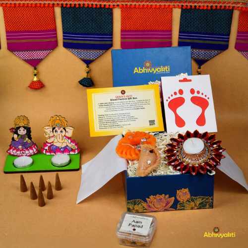 A festive Diwali hamper filled with an assortment of decorative items and treats. The hamper includes colorful floating diya, a box of mithai sweet candle, fragrant incense sticks, a small decorative toran, and festive Ganesh Lakshmi tealight alongwith tangy juicy mango roll up . The items are beautifully arranged in a festive box with vibrant, rich colors and intricate detailing, evoking the spirit of Diwali celebrations. The hamper is a perfect gift for the festive vibe