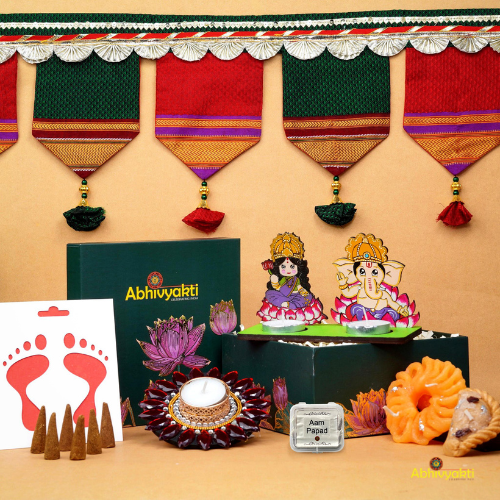 A festive Diwali hamper filled with an assortment of decorative items and treats. The hamper includes colorful floating diya, a box of mithai sweet candle, fragrant incense sticks, a small decorative toran, and festive Ganesh Lakshmi tealight alongwith tangy juicy mango roll up . The items are beautifully arranged in a festive box with vibrant, rich colors and intricate detailing, evoking the spirit of Diwali celebrations. The hamper is a perfect gift for the festive vibe