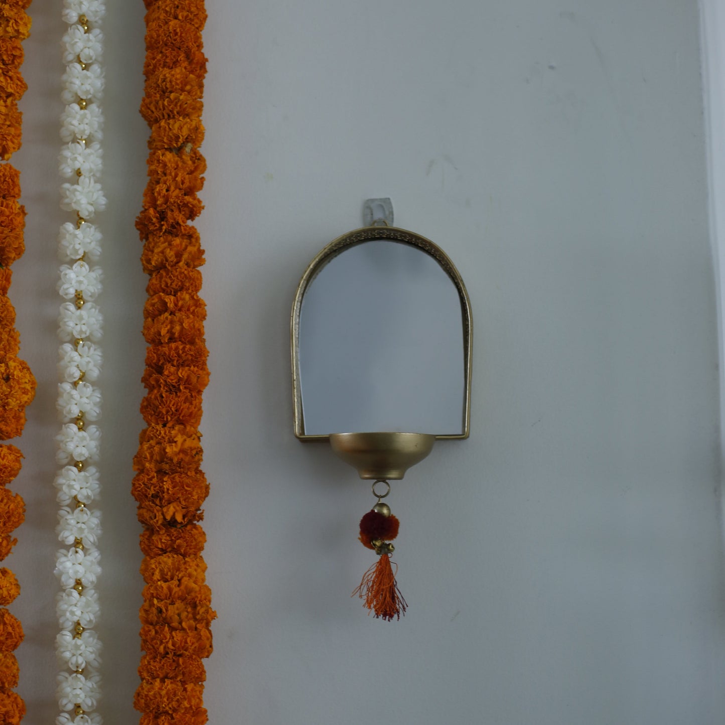 Decorative garland with a Mirror Tealight Holder on a white background