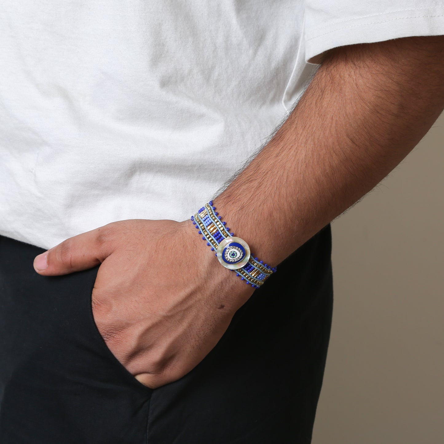 Crafted with precision, the bracelet comes with an adjustable strap, making it a perfect fit for every wrist. The evil eye charm, beautifully set in vibrant blues and whites, adds a pop of color and mystical allure to any outfit. Ideal for daily wear, it’s not just an accessory, but a reminder of positivity and well-being.