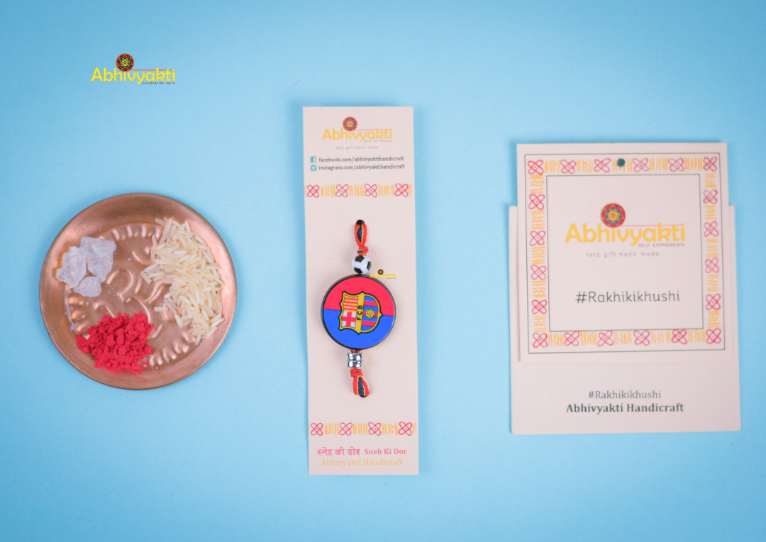FC Barcelona themed Rakhi featuring the FCB logo on a round dial with a football bead and multicolored band perfect for young football fans.