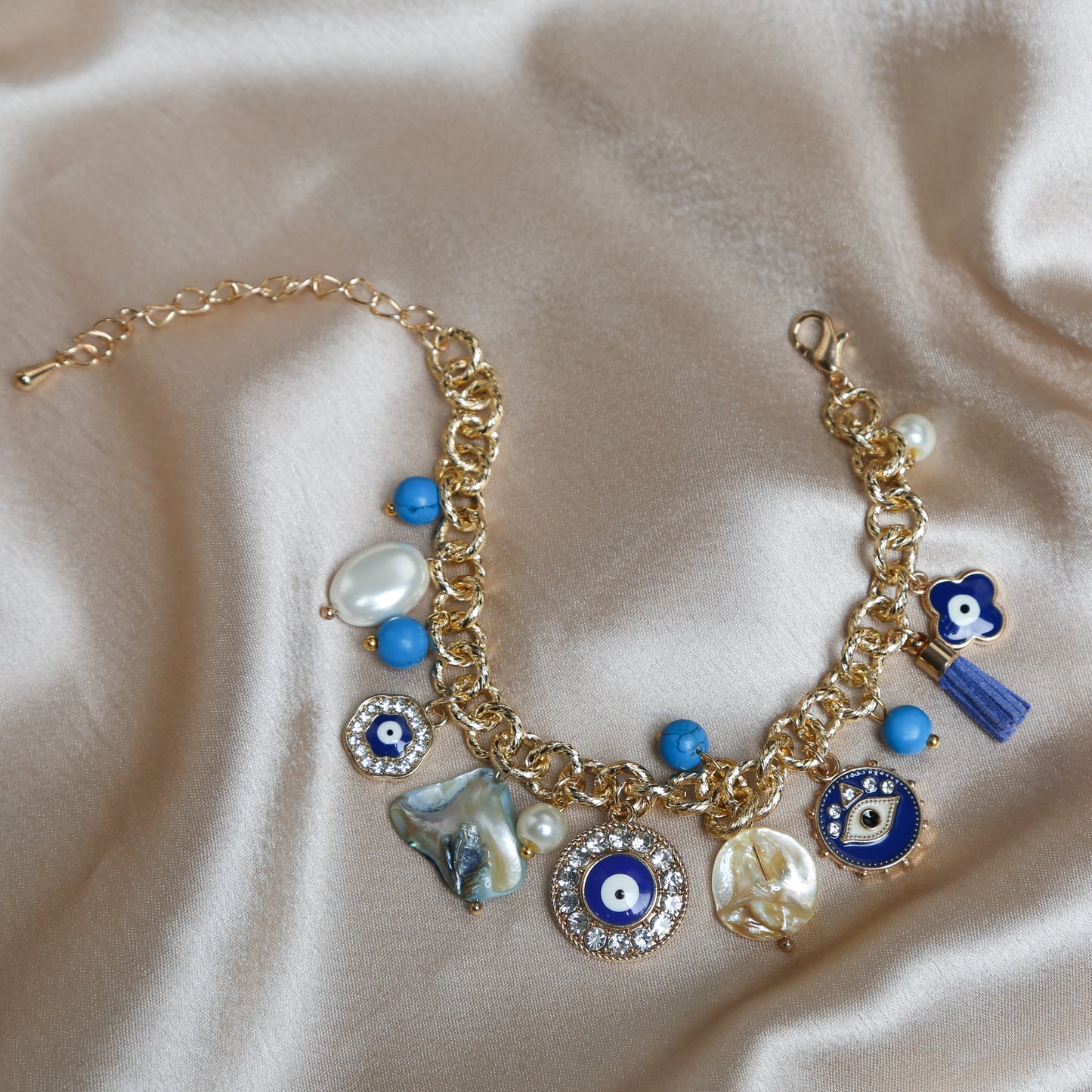 Crafted with precision, the bracelet comes with a soft lobster claw clasp, making it a perfect fit for every wrist. The evil eye charm, beautifully set in vibrant blues and whites, adds a pop of color and mystical allure to any outfit. Ideal for daily wear, it’s not just an accessory, but a reminder of positivity and well-being.