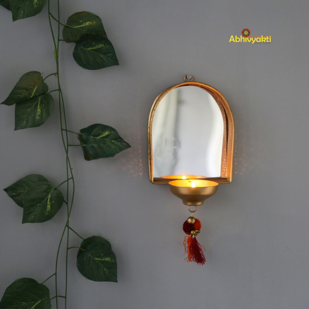 Wall Mirror tealight holder diya lit up on white wall