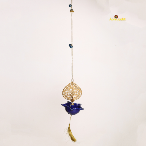 Decorative hanging peacock swagata diya with blue lotus design and gold accents on a white background