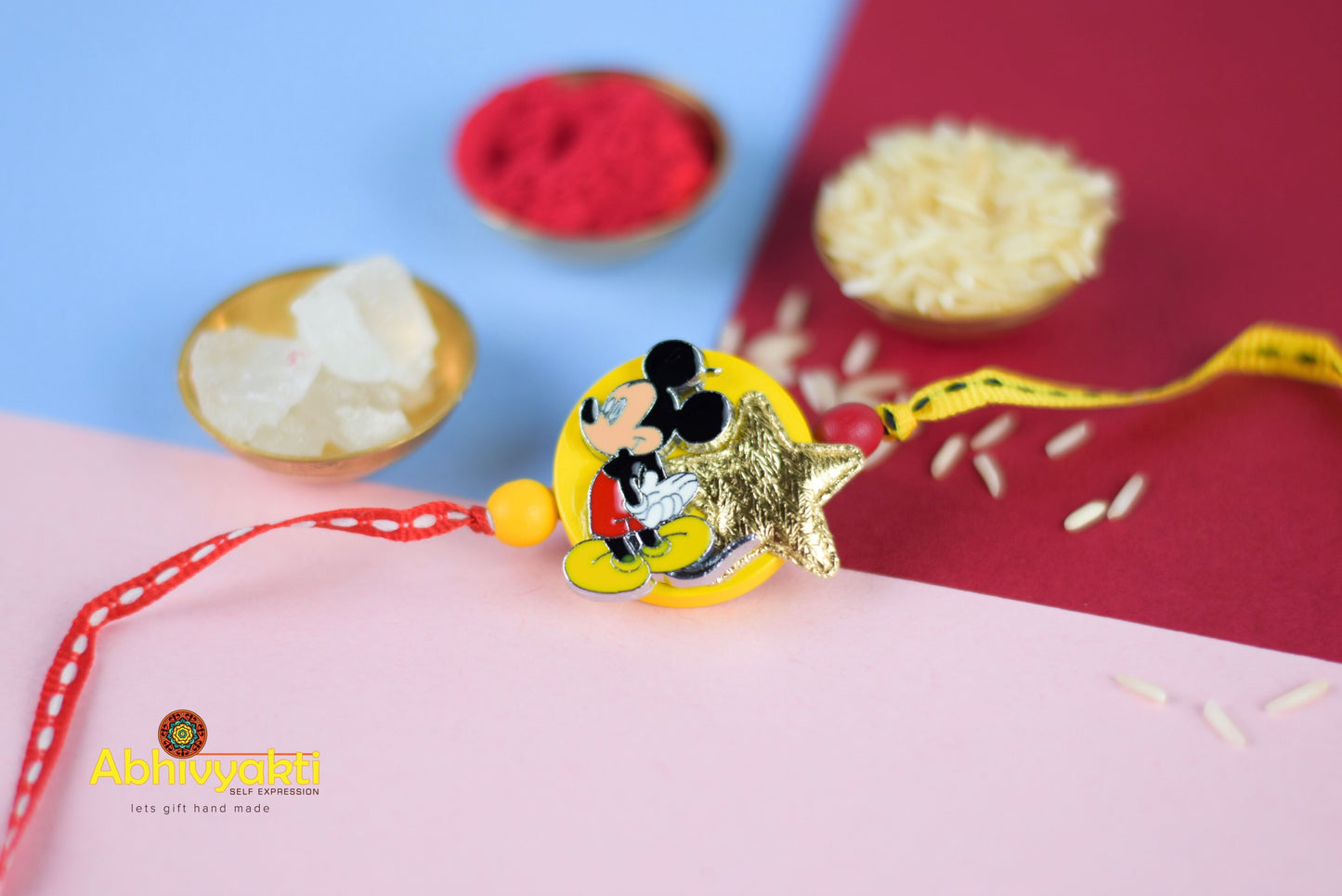 mickey mouse star rakhi with yellow and red ribbon