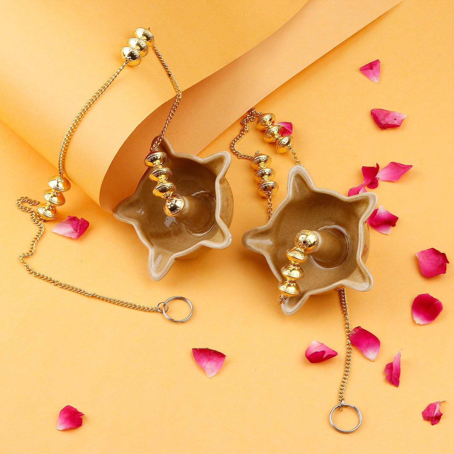 "Elegant wall-mounted Diwali diyas with intricate metal holders, designed to hang on the wall for a unique and stylish look. The diyas cast a soft, flickering light, creating a serene and festive ambiance for Diwali celebrations."