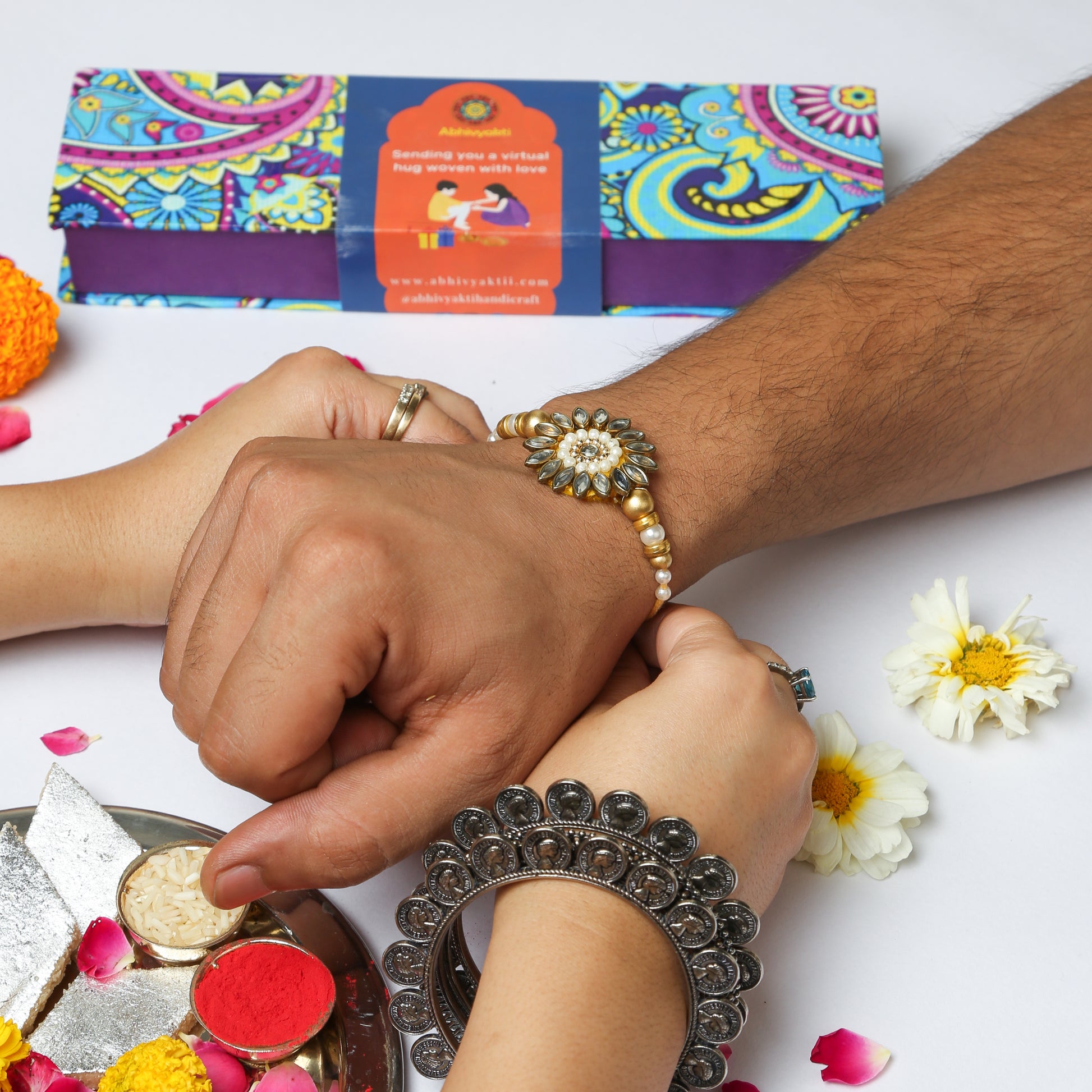 Celebrating rakshabandhan with sister tying beautiful Kundan floral rakhi to her brother