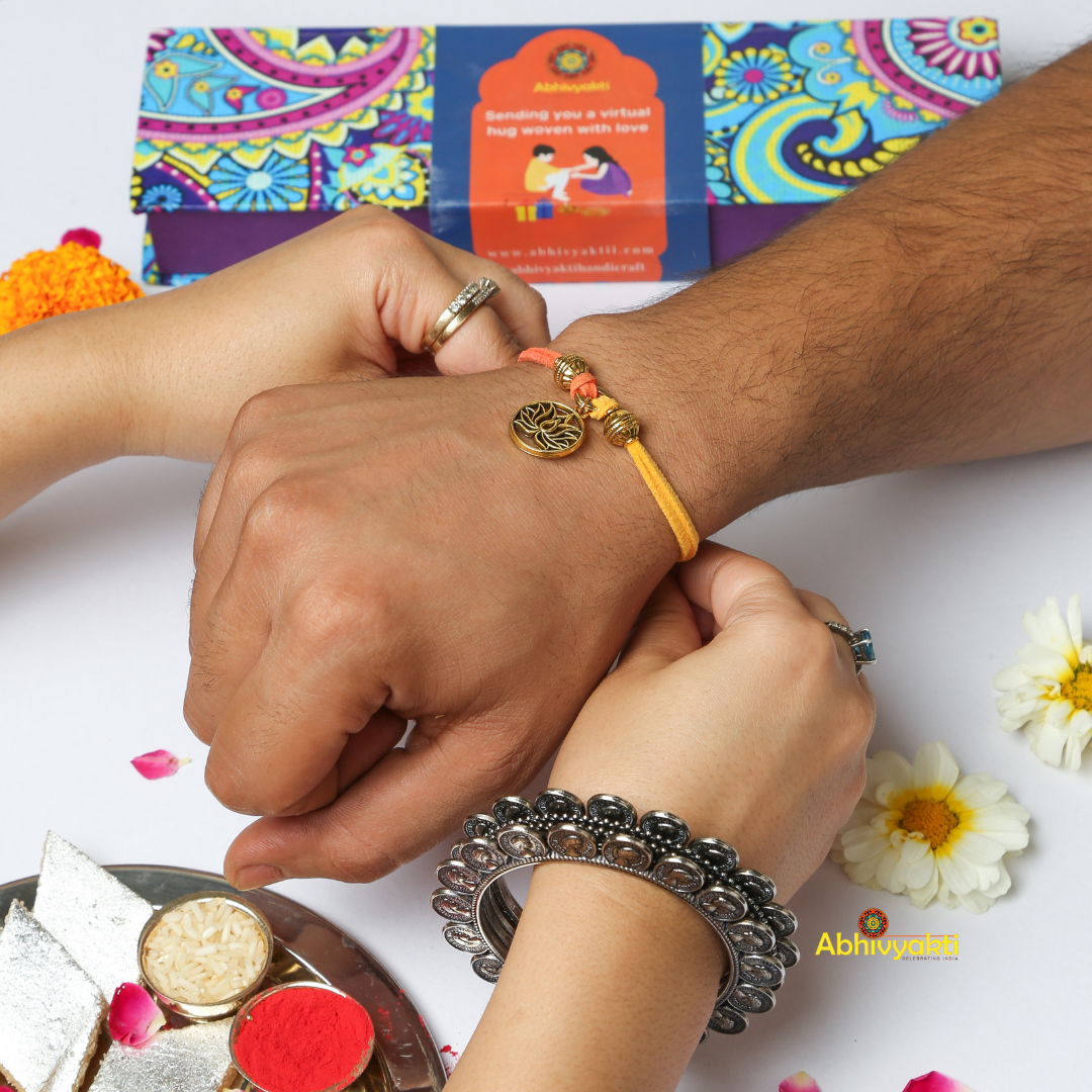 Celebrating rakshabandhan with sister tying beautiful Lotus design rakhi to her brother