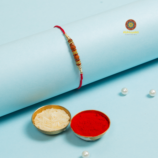 Traditional rakhi with pearl, and rudraksha beads.
