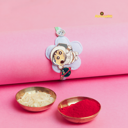 A vibrant Baby Astronaut Kids Rakhi bracelet for children, adorned with a cheerful cartoon character design, and comes with two bowls of roli and rice.