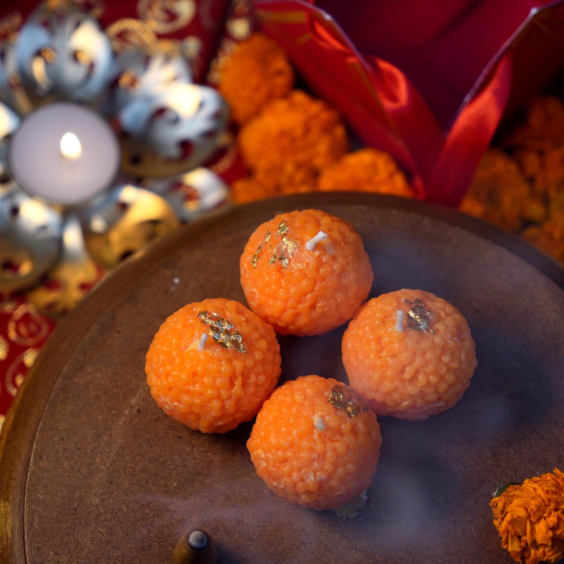 candles shaped like popular Indian sweet, laddoo. Each candle has vibrant colors and detailed textures, evoking the look of real mithai, making it a perfect gift for festivals or special occasions.