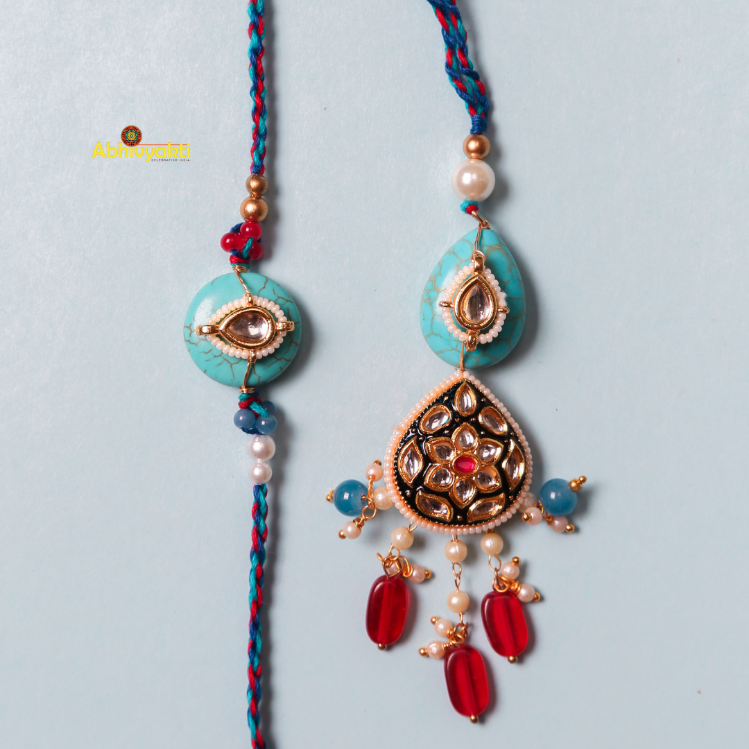 Blue and red Rakhi and lumba featuring a turquoise stone and intricate design.