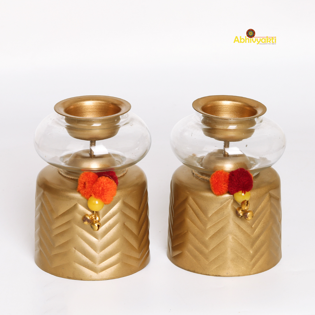 Anuya Tealight Holder Pair with shiny  glasses on a reflective surface with white background