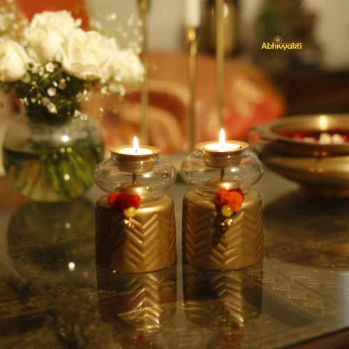 Close-up of Anuya Tealight Holder Pair with tealight on a reflective surface