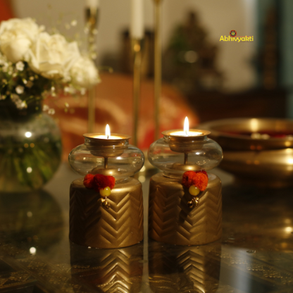 Decorative Anuya Tealight Holder Pair with flowers on a reflective surface