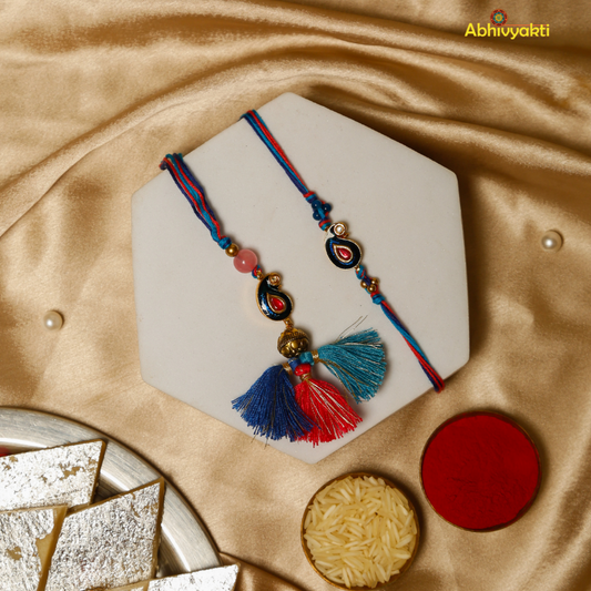 Two decorative rakhi lumba with colorful beads and tassels in blue, red, and on a golden background. One rakhi features small beads while the other has two large tassels and a gold bead.