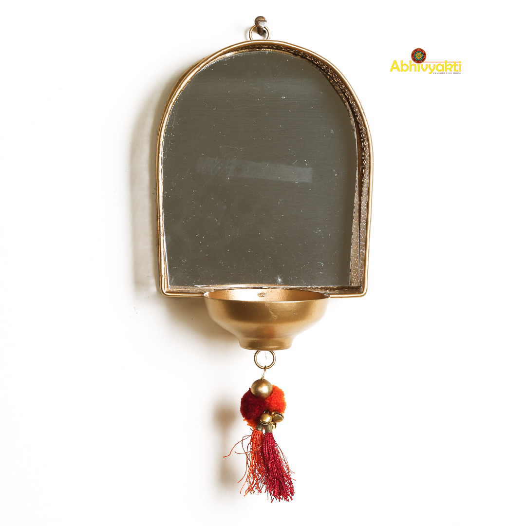 Decorative mirror tealight holder for Diwali decor with floral garlands on a plain background