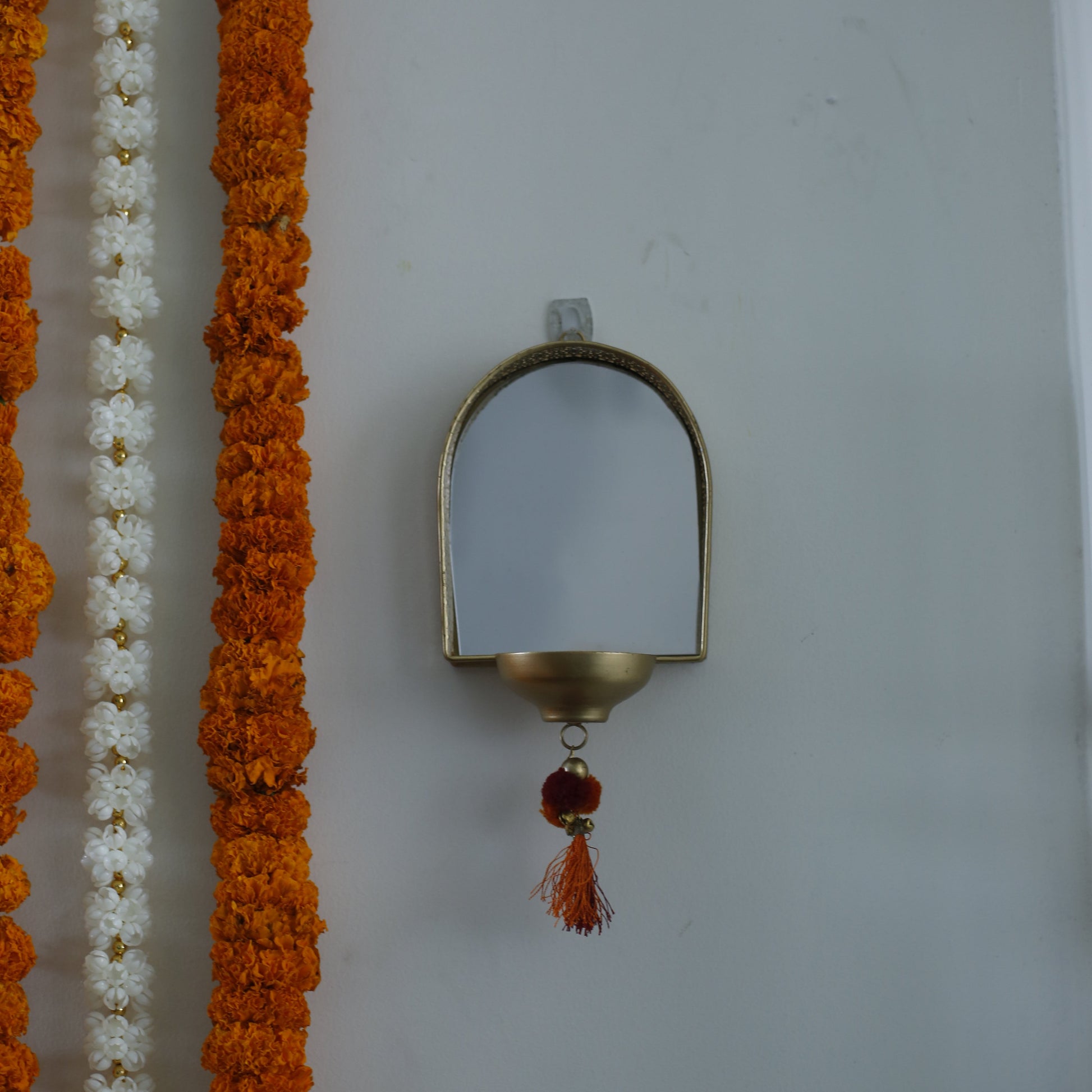 Decorative garland with a Mirror Tealight Holder on a white background