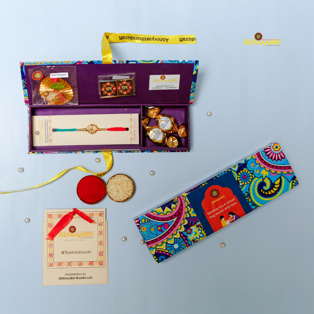 Elegant Rakhi featuring a golden lotus charm at the center, tied with contrasting red and teal threads. A minimal yet traditional design, perfect for celebrating Raksha Bandhan with a touch of symbolism and style