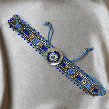 Crafted with precision, the bracelet comes with an adjustable strap, making it a perfect fit for every wrist. The evil eye charm, beautifully set in vibrant blues and whites, adds a pop of color and mystical allure to any outfit. Ideal for daily wear, it’s not just an accessory, but a reminder of positivity and well-being.