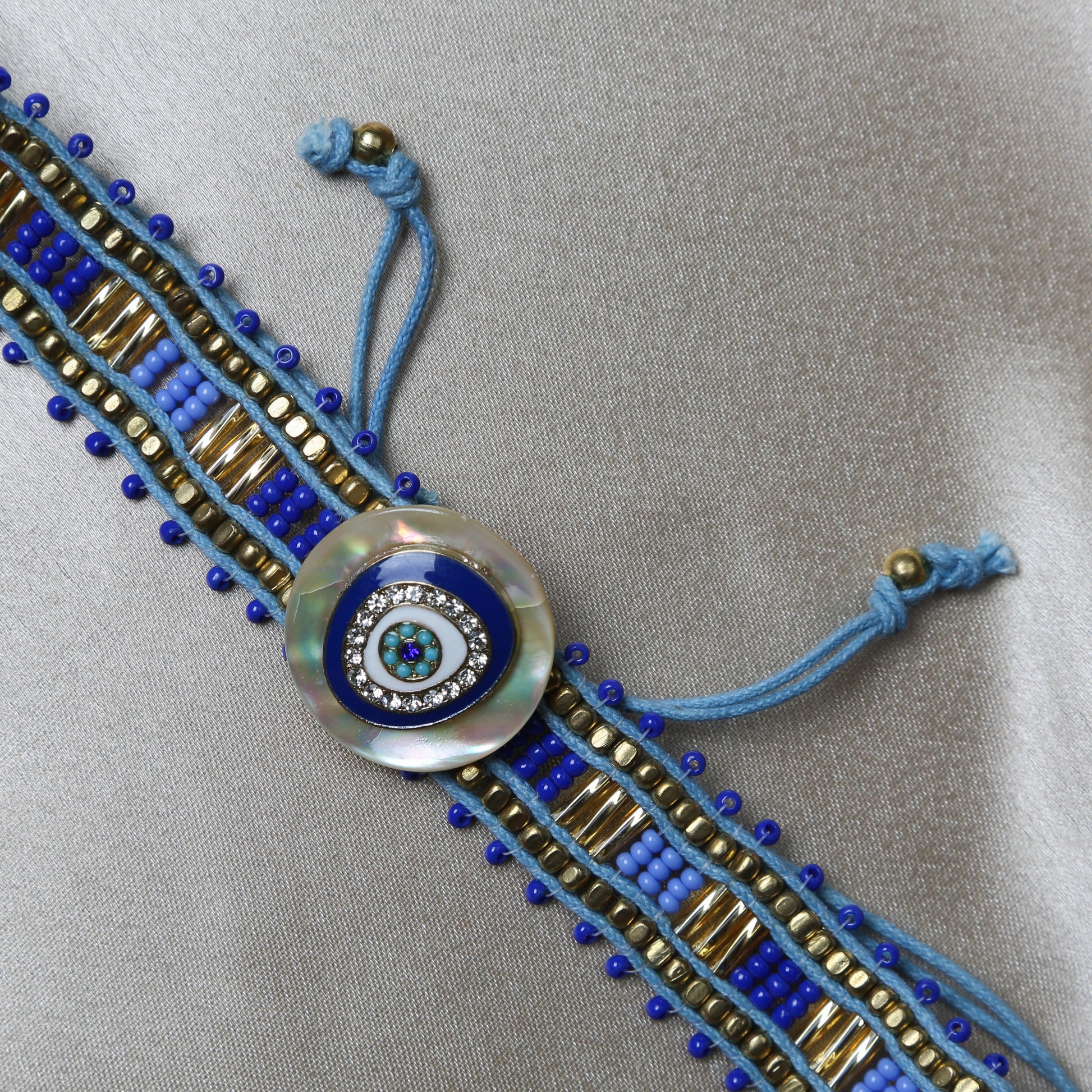 Crafted with precision, the bracelet comes with an adjustable strap, making it a perfect fit for every wrist. The evil eye charm, beautifully set in vibrant blues and whites, adds a pop of color and mystical allure to any outfit. Ideal for daily wear, it’s not just an accessory, but a reminder of positivity and well-being.