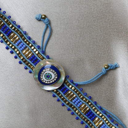 Crafted with precision, the bracelet comes with an adjustable strap, making it a perfect fit for every wrist. The evil eye charm, beautifully set in vibrant blues and whites, adds a pop of color and mystical allure to any outfit. Ideal for daily wear, it’s not just an accessory, but a reminder of positivity and well-being.