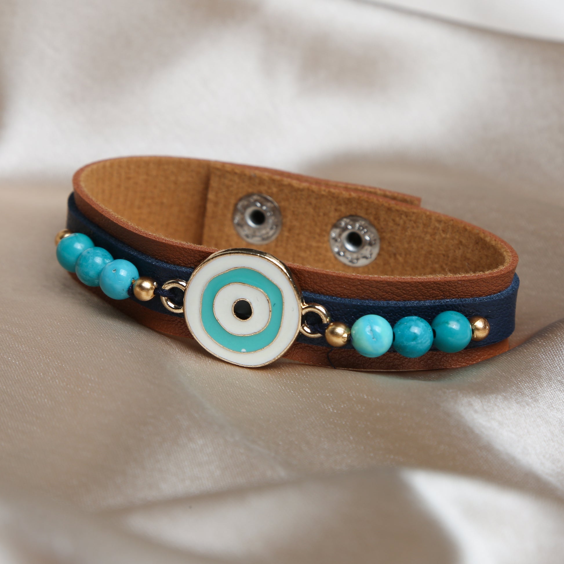 Crafted with precision, the bracelet comes with an adjustable strap, making it a perfect fit for every wrist. The evil eye charm, beautifully set in vibrant blues and whites, adds a pop of color and mystical allure to any outfit. Ideal for daily wear, it’s not just an accessory, but a reminder of positivity and well-being.
