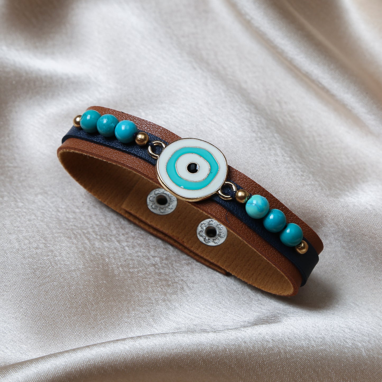 Crafted with precision, the bracelet comes with an adjustable strap, making it a perfect fit for every wrist. The evil eye charm, beautifully set in vibrant blues and whites, adds a pop of color and mystical allure to any outfit. Ideal for daily wear, it’s not just an accessory, but a reminder of positivity and well-being.