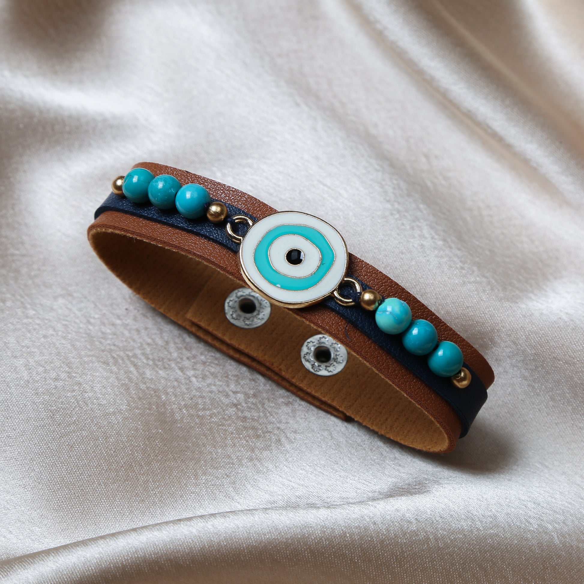 Crafted with precision, the bracelet comes with an adjustable strap, making it a perfect fit for every wrist. The evil eye charm, beautifully set in vibrant blues and whites, adds a pop of color and mystical allure to any outfit. Ideal for daily wear, it’s not just an accessory, but a reminder of positivity and well-being.