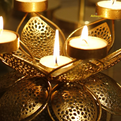 Decorative Padam Tealight Holder Table Top with candles and flowers on a reflective surface