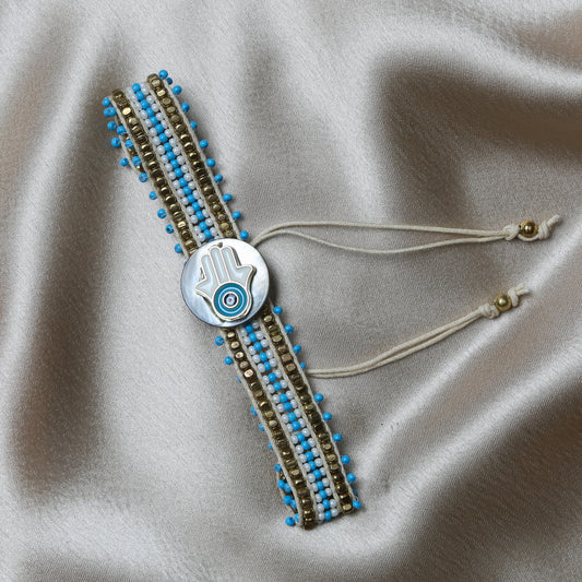 Made with an adjustable strap, this unisex bracelet ensures a perfect fit for any wrist size, making it both comfortable and stylish. The charm’s delicate detailing and its association with ancient traditions bring a sense of cultural elegance and spiritual protection to your wardrobe.