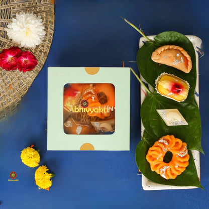 Decorative, usable soy wax candles designed to resemble traditional Indian sweets like gujiya, peda, imarti, and barfi, beautifully arranged in a pastel green gift box with a transparent window.  ideal for gifting during Indian festival