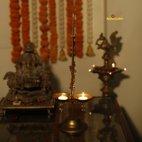 Decorative Kalp Taru Tealight Holder Table Top. Decorated with wall art with a pattern of orange and white shapes on a plain background