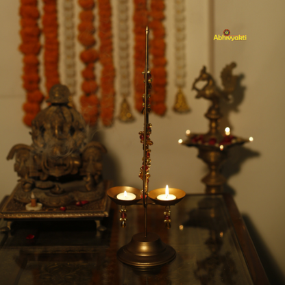 Decorative Kalp Taru Tealight Holder Table Top. Decorated with wall art with a pattern of orange and white shapes on a plain background