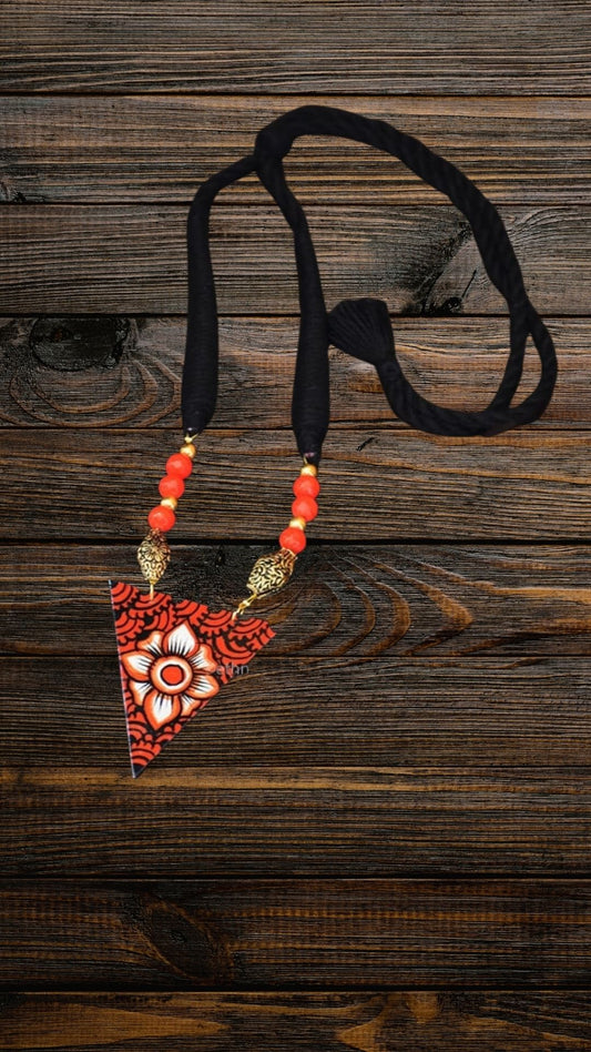 This beautiful necklace is hand painted and an exquisite Indian Jewellery inspired by Kerala Mural Art designed on crafted wood. It is surely an elegant wear for any occasion. A perfect head turner and a conversation starter..