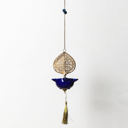 Decorative hanging ornament Peacock Swagata with blue bowl and gold filigree on a white background