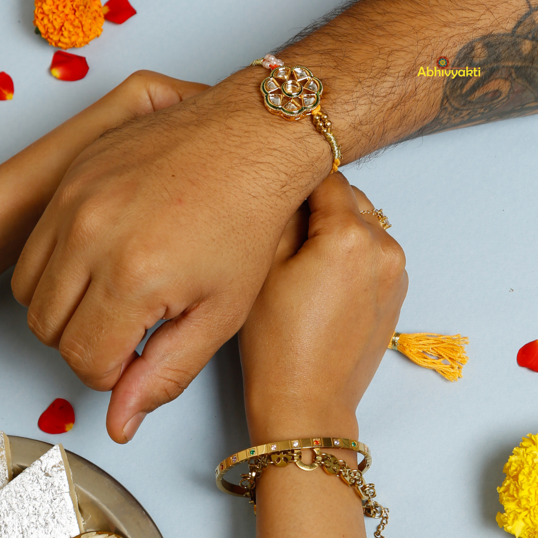 A vibrant Premium Rakhi embellished with stones, showcasing a yellow and red thread for festive celebrations
