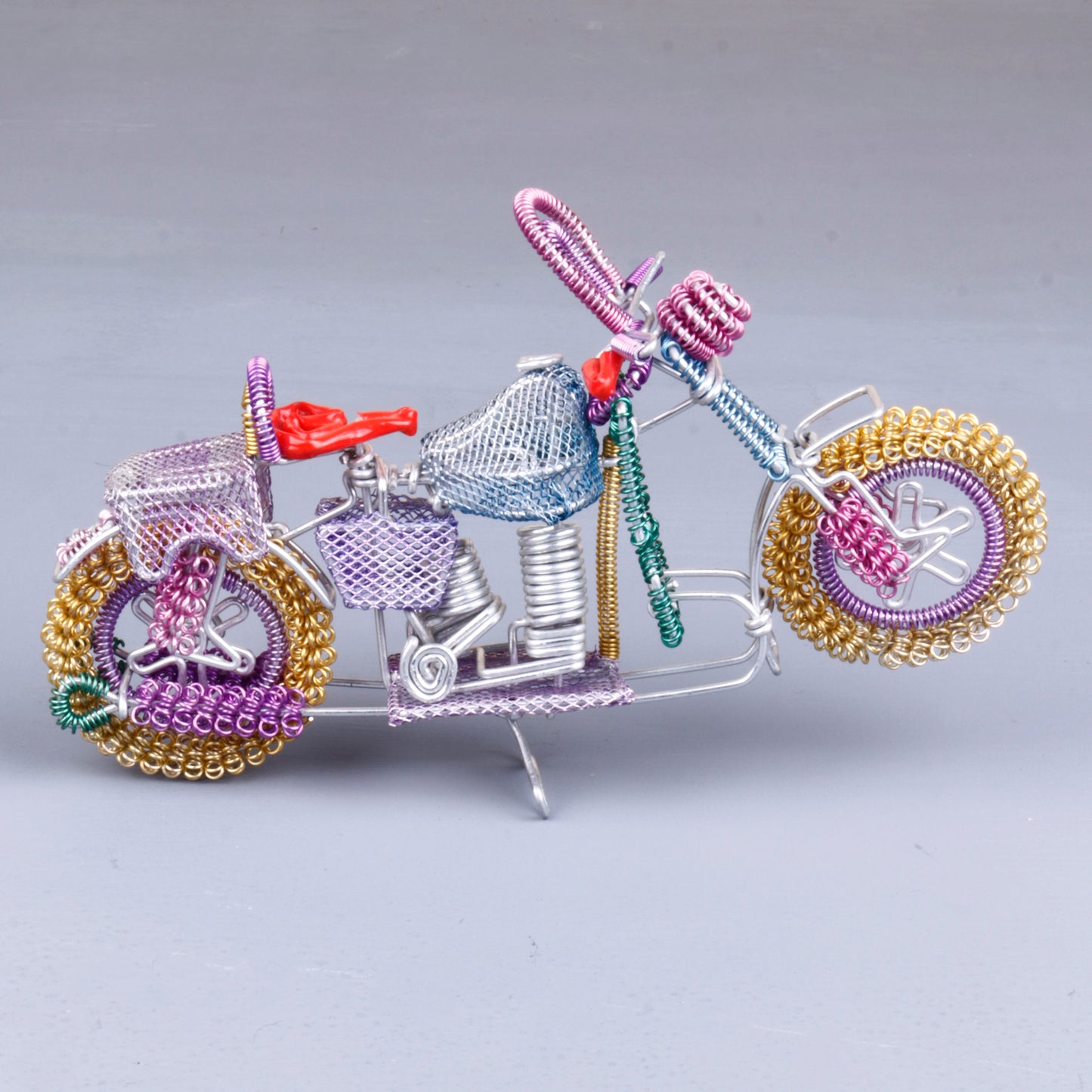 A handmade wire motorbike decor piece crafted with intricate detailing. The wire frame captures the sleek and dynamic shape of a motorbike, showcasing fine craftsmanship. Perfect for home decor or as a unique gift for bike enthusiasts