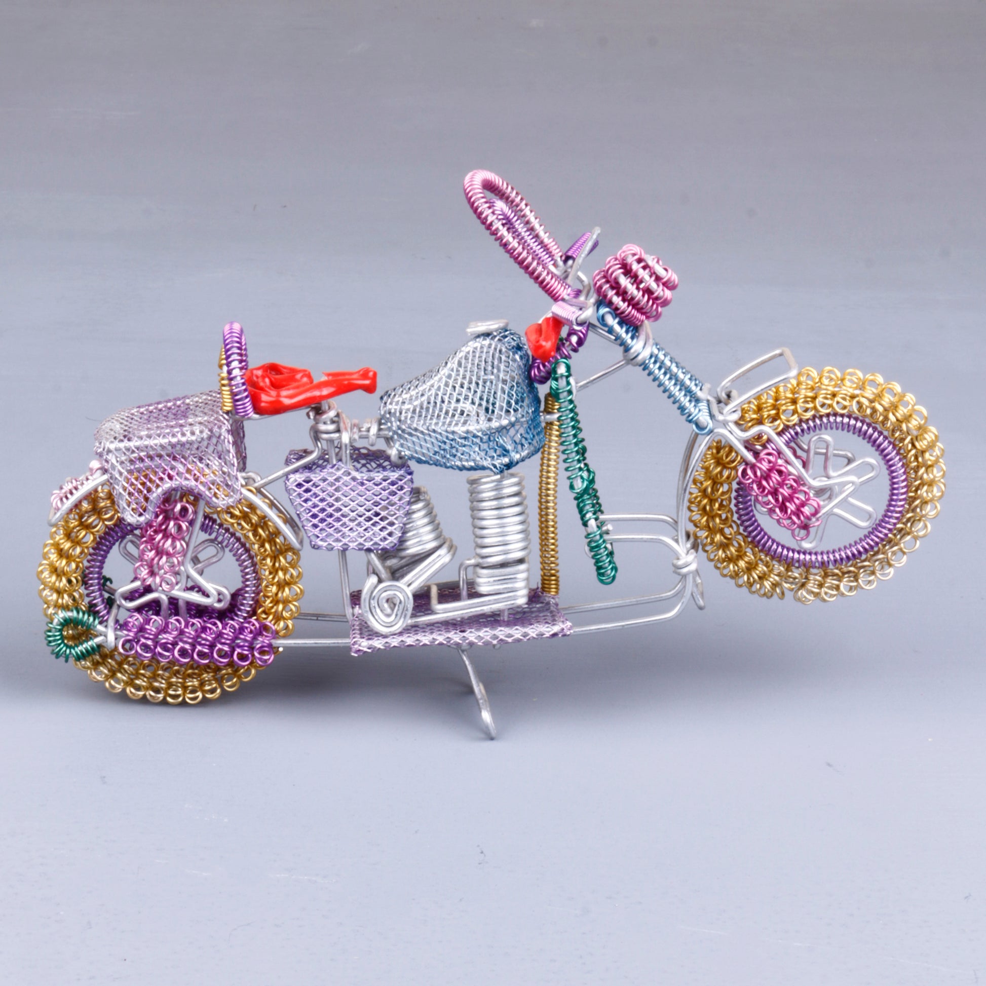 A handmade wire motorbike decor piece crafted with intricate detailing. The wire frame captures the sleek and dynamic shape of a motorbike, showcasing fine craftsmanship. Perfect for home decor or as a unique gift for bike enthusiasts
