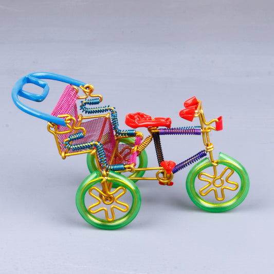 A handmade wire rickshaw decor piece crafted with intricate detailing. The wire frame captures the sleek and dynamic shape of a rickshaw, showcasing fine craftsmanship. Perfect for home decor or as a unique gift for kids