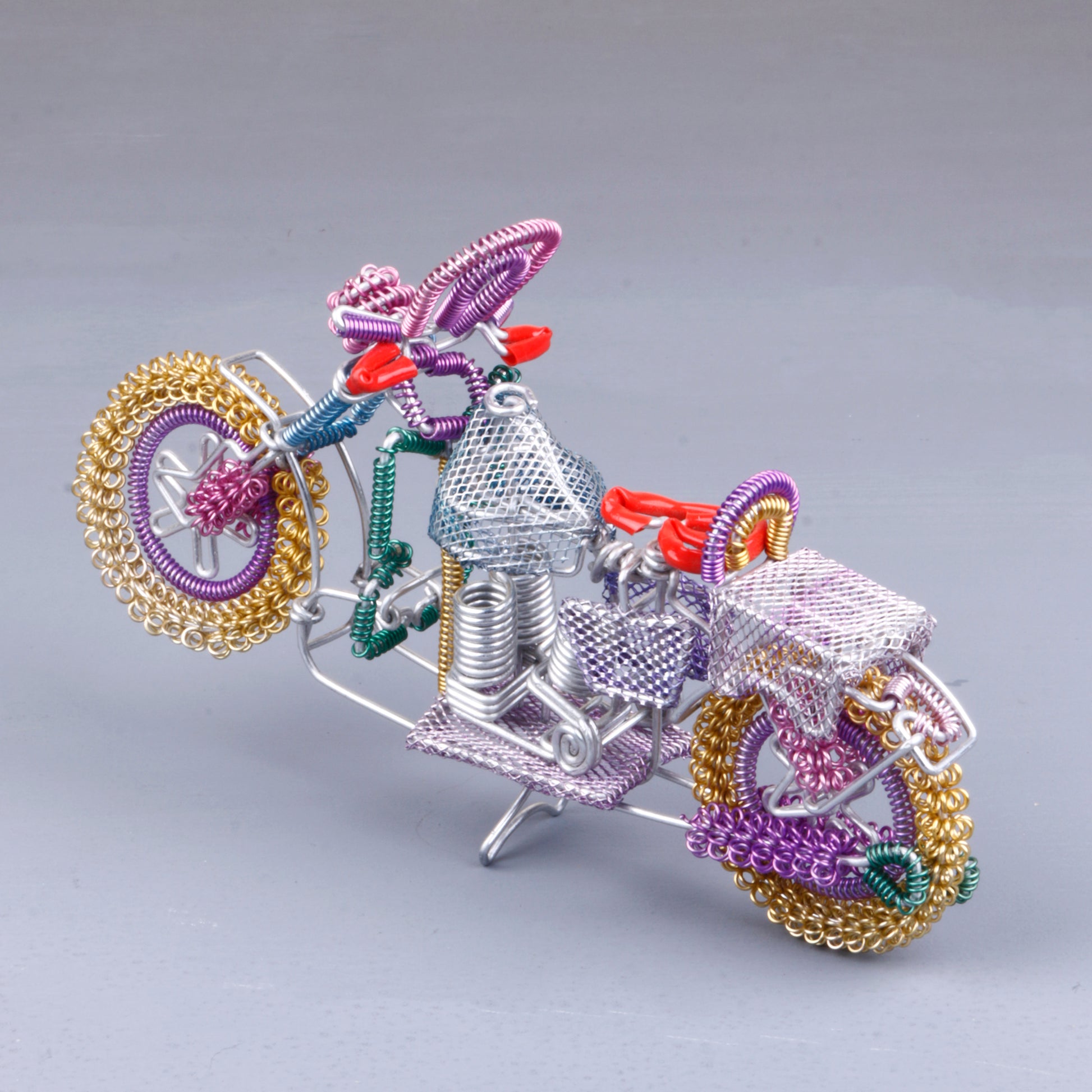 A handmade wire motorbike decor piece crafted with intricate detailing. The wire frame captures the sleek and dynamic shape of a motorbike, showcasing fine craftsmanship. Perfect for home decor or as a unique gift for bike enthusiasts