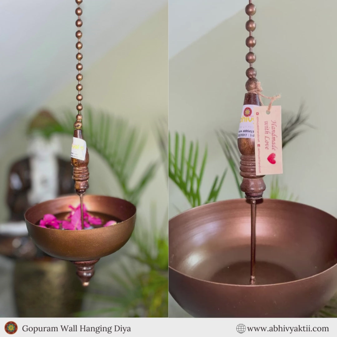 "Elegant wall-mounted Diwali diyas with intricate metal holders, designed to hang on the wall for a unique and stylish look. The diyas cast a soft, flickering light, creating a serene and festive ambiance for Diwali celebrations."