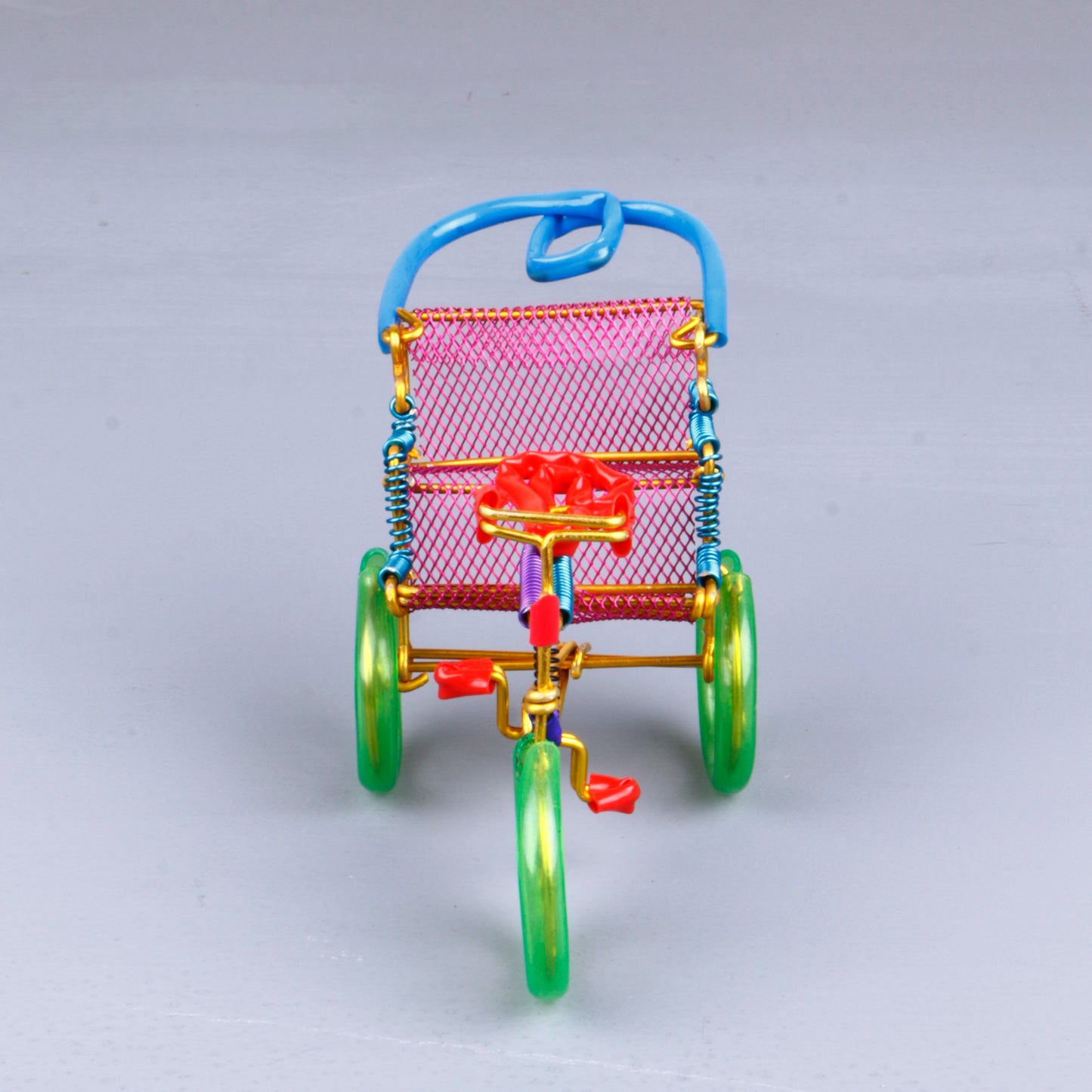 A handmade wire rickshaw decor piece crafted with intricate detailing. The wire frame captures the sleek and dynamic shape of a rickshaw, showcasing fine craftsmanship. Perfect for home decor or as a unique gift for kids