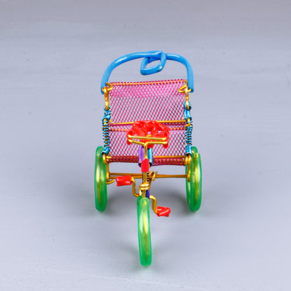 A handmade wire rickshaw decor piece crafted with intricate detailing. The wire frame captures the sleek and dynamic shape of a rickshaw, showcasing fine craftsmanship. Perfect for home decor or as a unique gift for kids