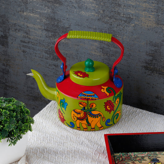 "A vibrant, handpainted kettle with quirky designs and bold colors, featuring intricate Indian folk art. The kettle is adorned with playful motifs and patterns, perfect as a decorative statement piece for a creative and culturally inspired home."